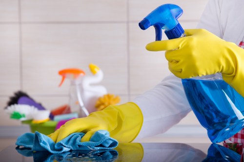 Local cleaners vacuuming and dusting a commercial workspace in SW9