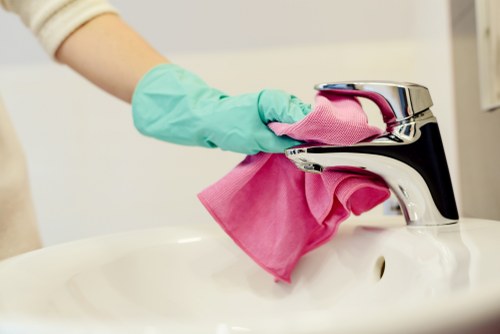 Cleaner in SW9 using safety equipment during a professional cleaning task