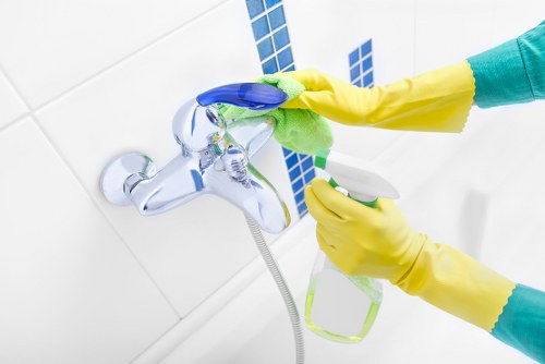 Professional cleaner working in a kitchen in SW9