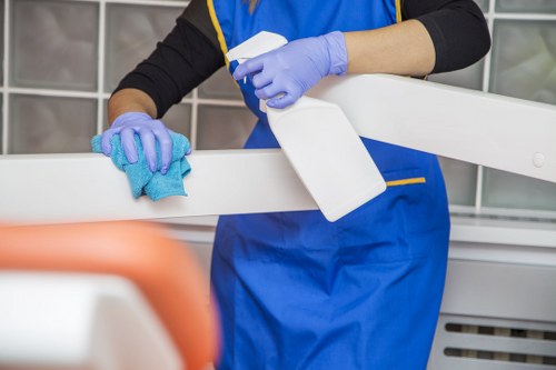 Cleaner maintaining stairs and bannisters in a communal area